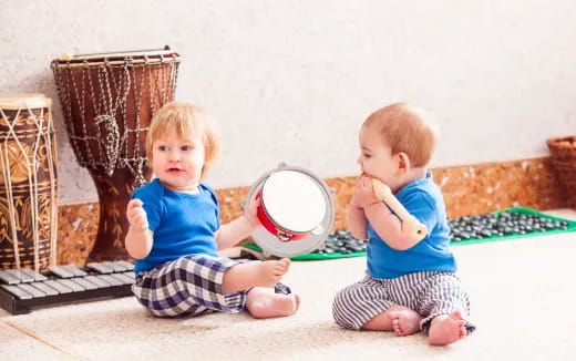 two babies sitting on the floor