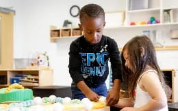 a boy and girl in a kitchen