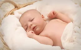 a baby sleeping on a blanket