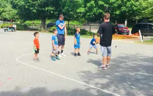 a group of kids playing in a parking lot