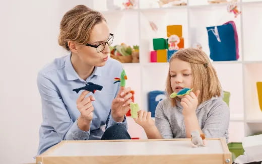 a person and a girl with toys