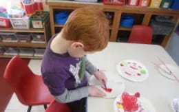 a child painting on a table