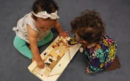 a couple of girls playing chess