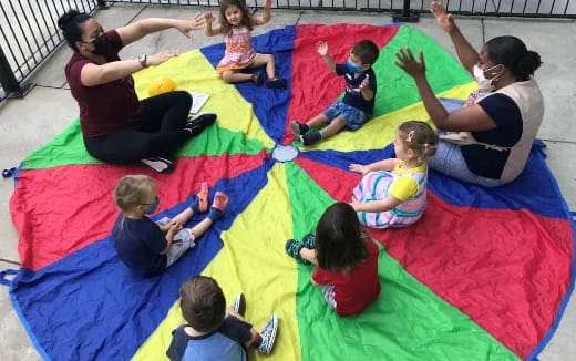 a group of people on a colorful mat