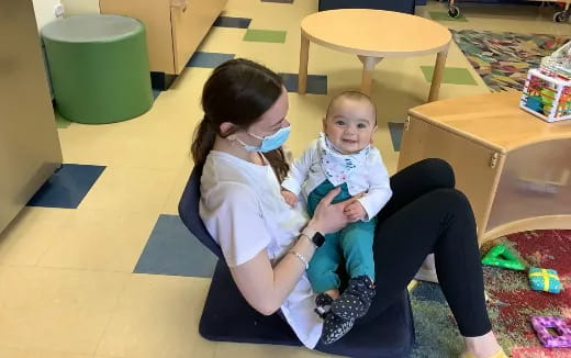 a person and a child sitting on the floor