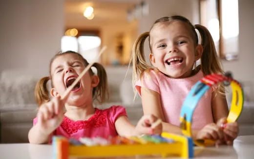a couple of young girls playing with toys