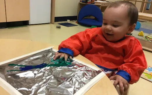 a baby playing with plastic toys