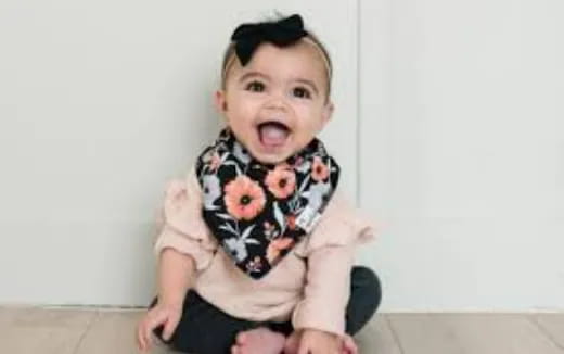 a baby sitting on a couch