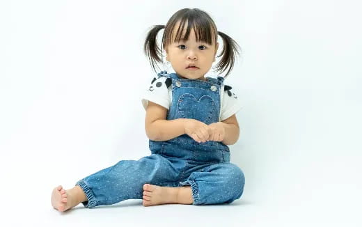 a baby sitting on the floor