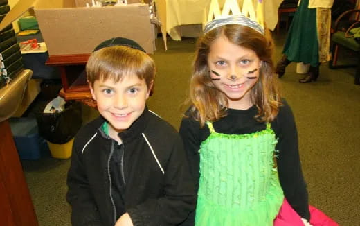 a boy and girl posing for a picture