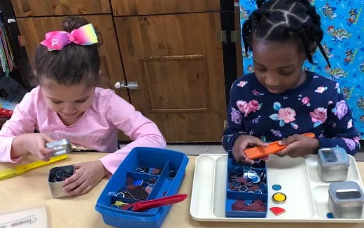 a couple of young girls playing with toys