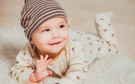 a baby lying on a blanket