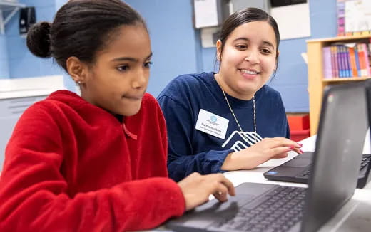 a few young women working on a laptop