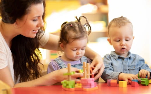 a person and two children playing with toys