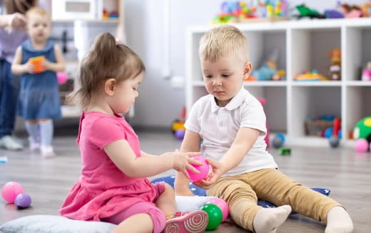 a couple of children playing with toys