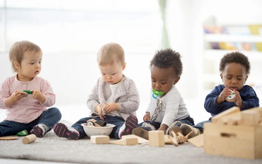 a group of kids sitting on the floor eating