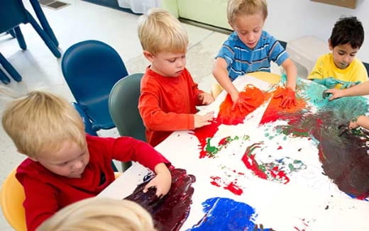 a group of children playing with a puzzle