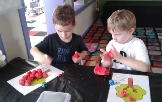 two boys sitting at a table