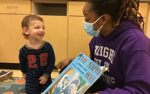 a person and a boy looking at a book