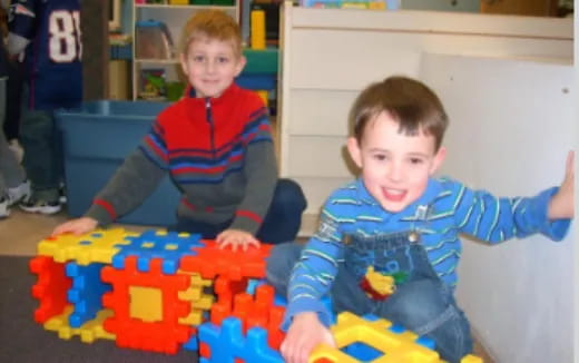 two boys playing with a toy