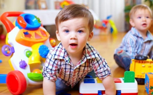 a couple of babies playing with toys
