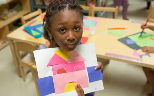 a young girl holding a box