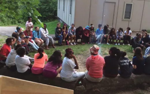 a group of people sitting on the ground
