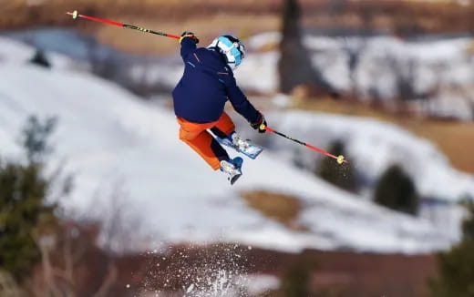 a person jumping in the air on skis