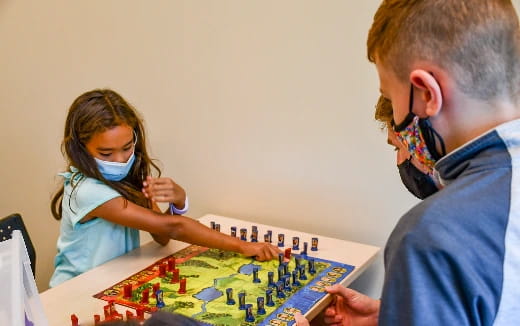 a man and a woman playing a board game