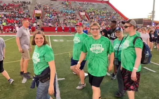 a group of people in green shirts