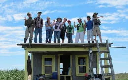 a group of people standing on top of a building