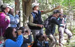 a person holding a gun in front of a group of people