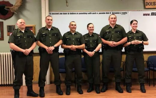 a group of men in green uniforms