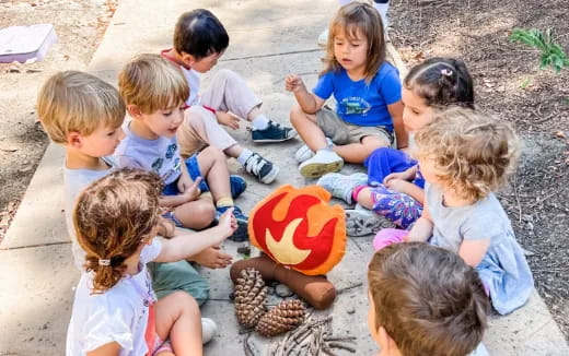 a group of children sitting on the ground