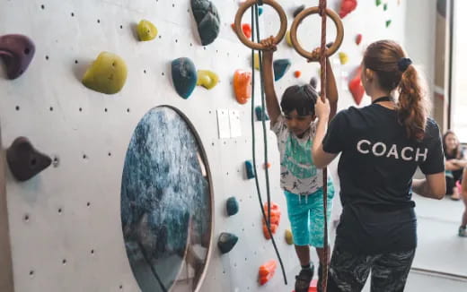 a group of people climbing a wall
