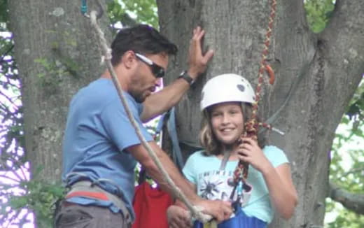 a man and a woman climbing a tree