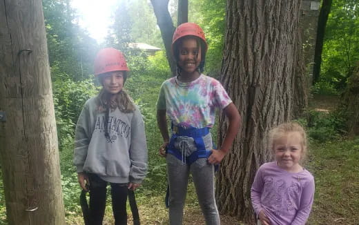a group of people standing next to a tree