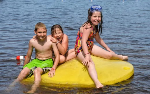 a group of people on a floating object in the water