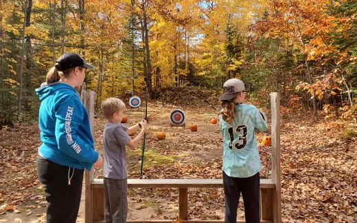 a group of people playing with a bow and arrow