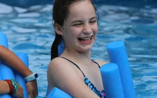 a girl in a swimsuit in a pool