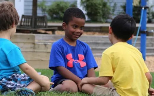 a group of boys sitting on the ground