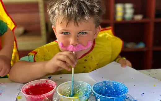 a child eating from a straw
