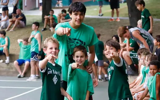 a group of children in green shirts