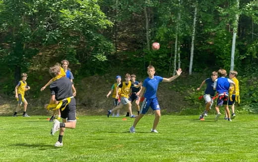 a group of people playing a game of frisbee