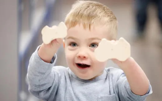 a baby holding a piece of food