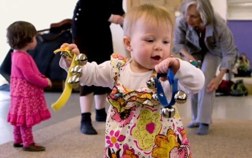 a baby holding a toy