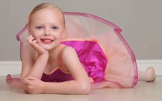a baby in a pink swimsuit