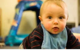 a baby looking at the camera