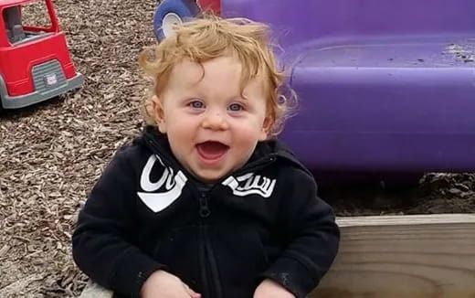 a baby sitting on the ground