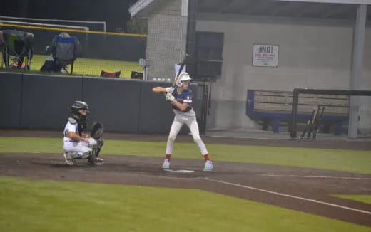 a baseball player prepares to swing a bat